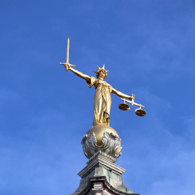A gold statue of Lady Liberty sits atop the Old Bailey building in London. The Old Bailey is the Central Criminal Court of England and Wales.